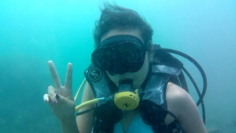 Beginner diver making a peace sign during intro scuba in Tanjung Benoa