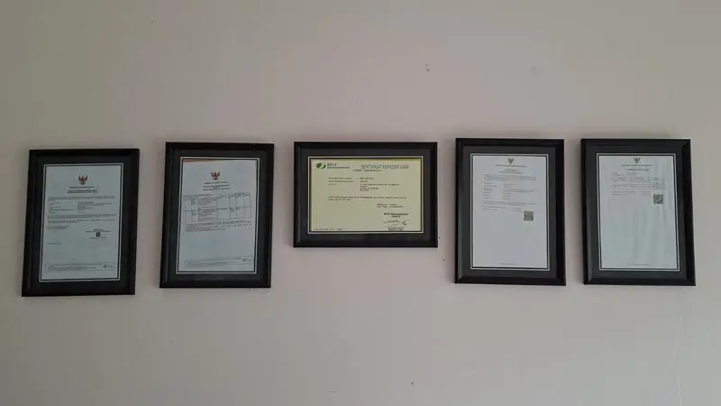 Framed certificates displayed on the Wira Tour Bali office wall.