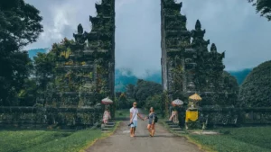 Travelers at an ornate Balinese gate, a famous place in Bali
