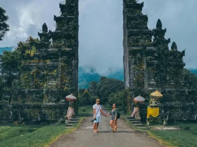 Travelers at an ornate Balinese gate, a famous place in Bali