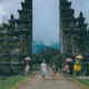 Travelers at an ornate Balinese gate, a famous place in Bali