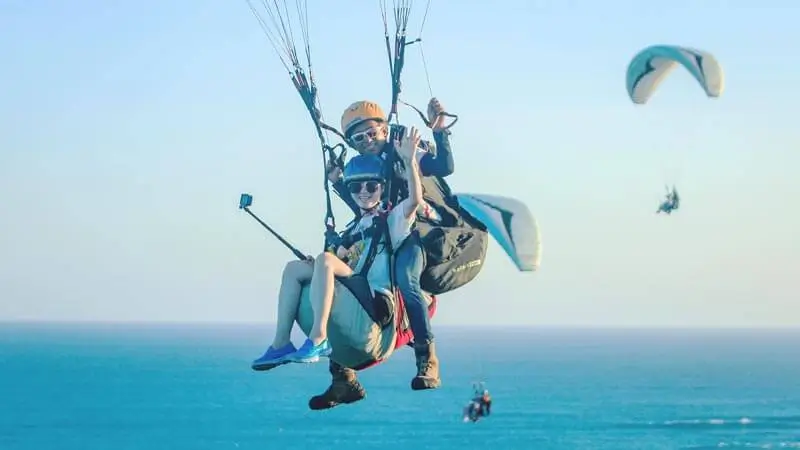 Tandem Riug Paragliding over the ocean off Sawangan, Nusa Dua