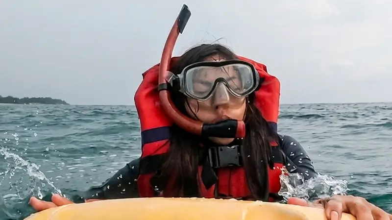 Guest wearing a life jacket at the water surface