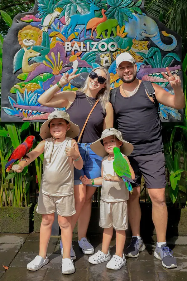 Family posing at the Bali Zoo entrance after ticket check-in