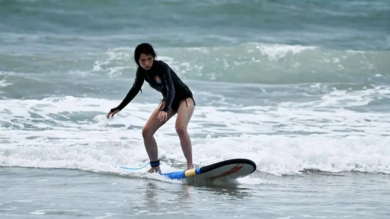 Beginner surfer practicing on small waves near the shore