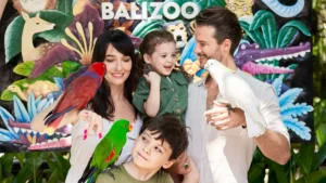 Family taking a supervised bird photo near the Bali Zoo sign