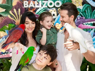 Family taking a supervised bird photo near the Bali Zoo sign