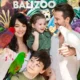 Family taking a supervised bird photo near the Bali Zoo sign
