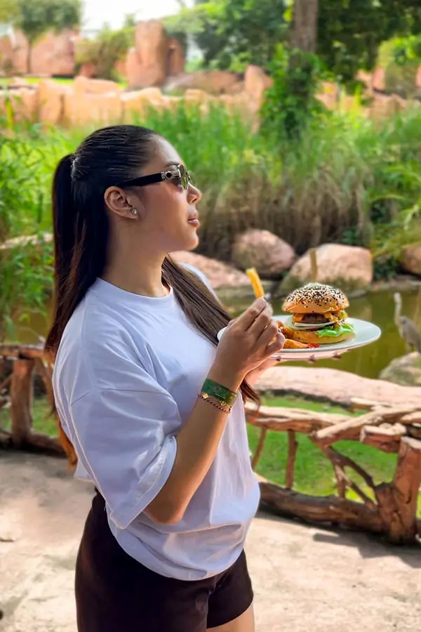 Guest holding lunch near a pond inside the zoo