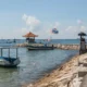 Tanjung Benoa Beach coastline with boats and a coastal path