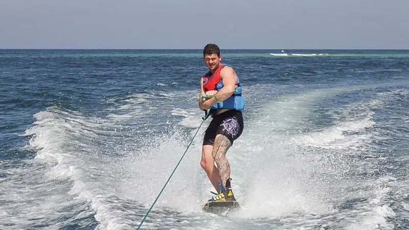 Participant wakeboarding behind a speedboat at Tanjung Benoa, Bali.